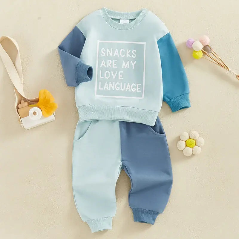 Snacks Are My Love Language baby tracksuit set in blue, styled flat lay