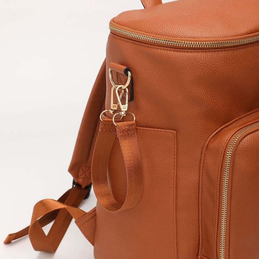 Sofia baby backpack tan - closeupshowing pebbled leather and pram clip