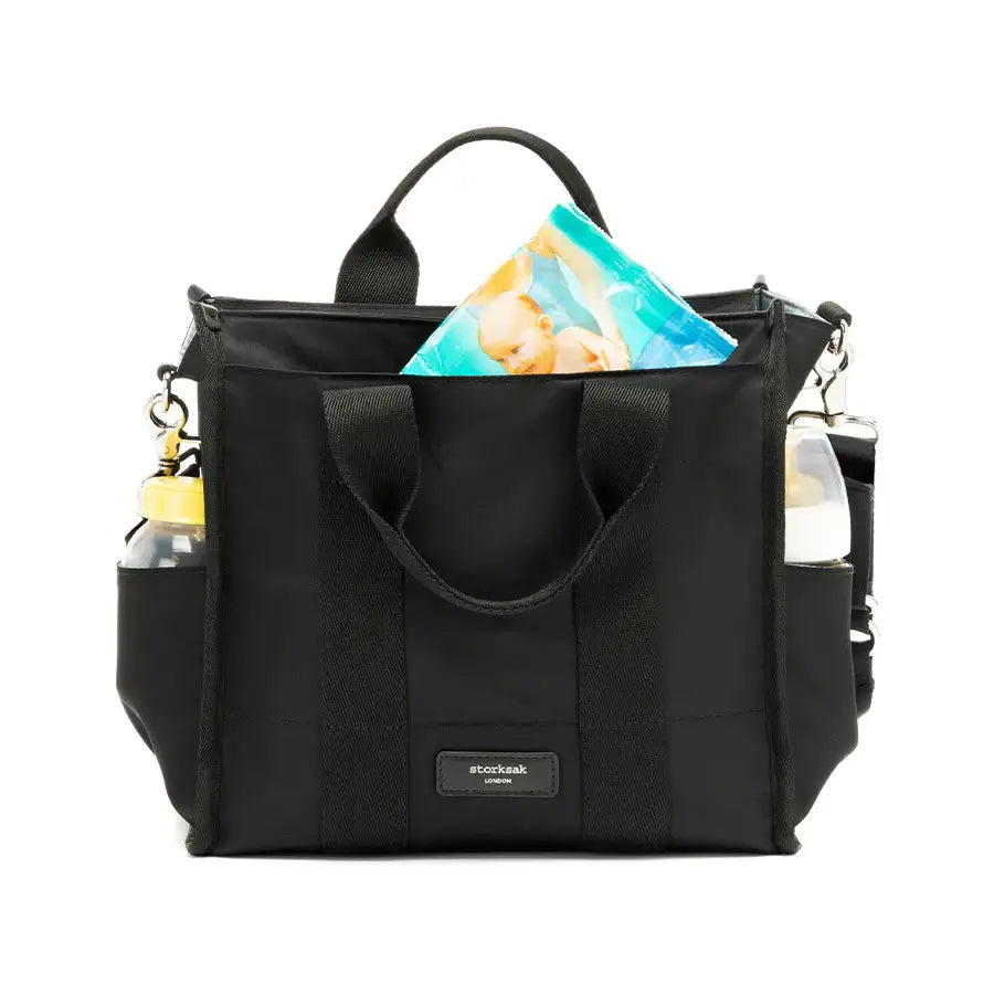 Storksak Thea Tote & Compact Nappy Bag, lightweight black design with baby essentials, ideal for modern parents.