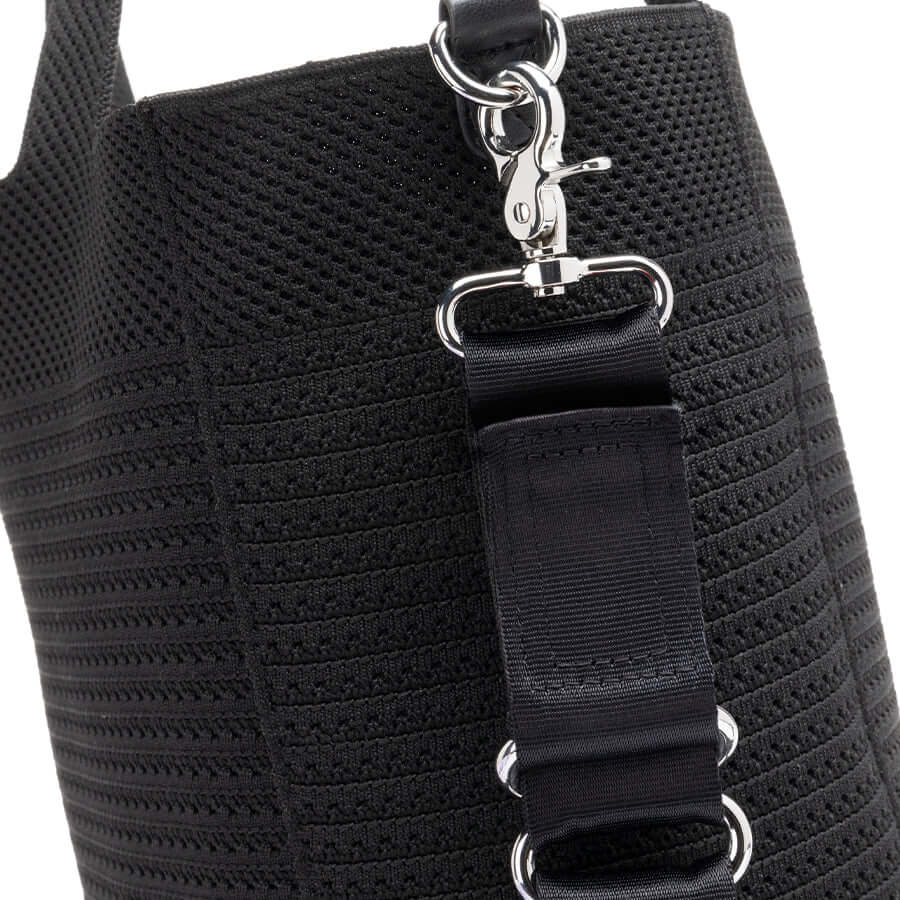 Close-up of Storksak Thea Tote showing woven design and secure clip for practical use.