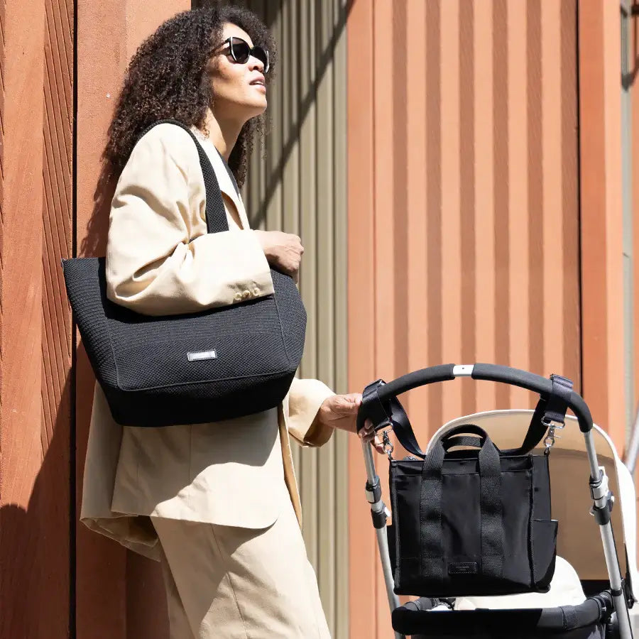 Stylish mum with Storksak Thea Tote and compact nappy bag