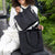 Mum using the Storksak Thea Tote and compact nappy bag