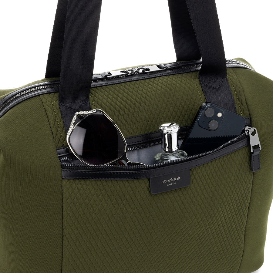 Storksak Stevie Luxe Nappy Bag with phone, sunglasses, and perfume in zip pocket