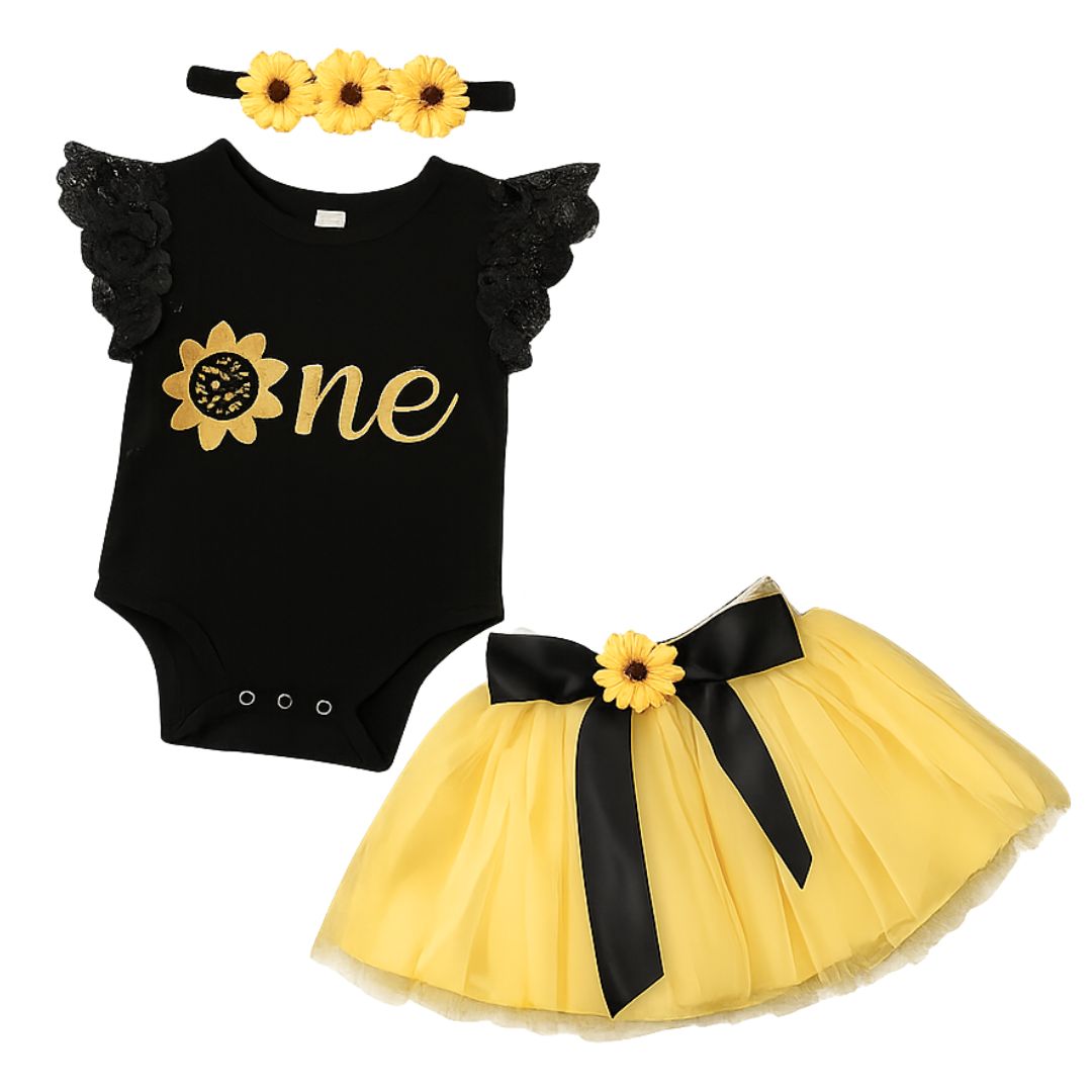 Baby girl first birthday outfit with black "One" bodysuit, yellow tutu skirt and sunflower headband
