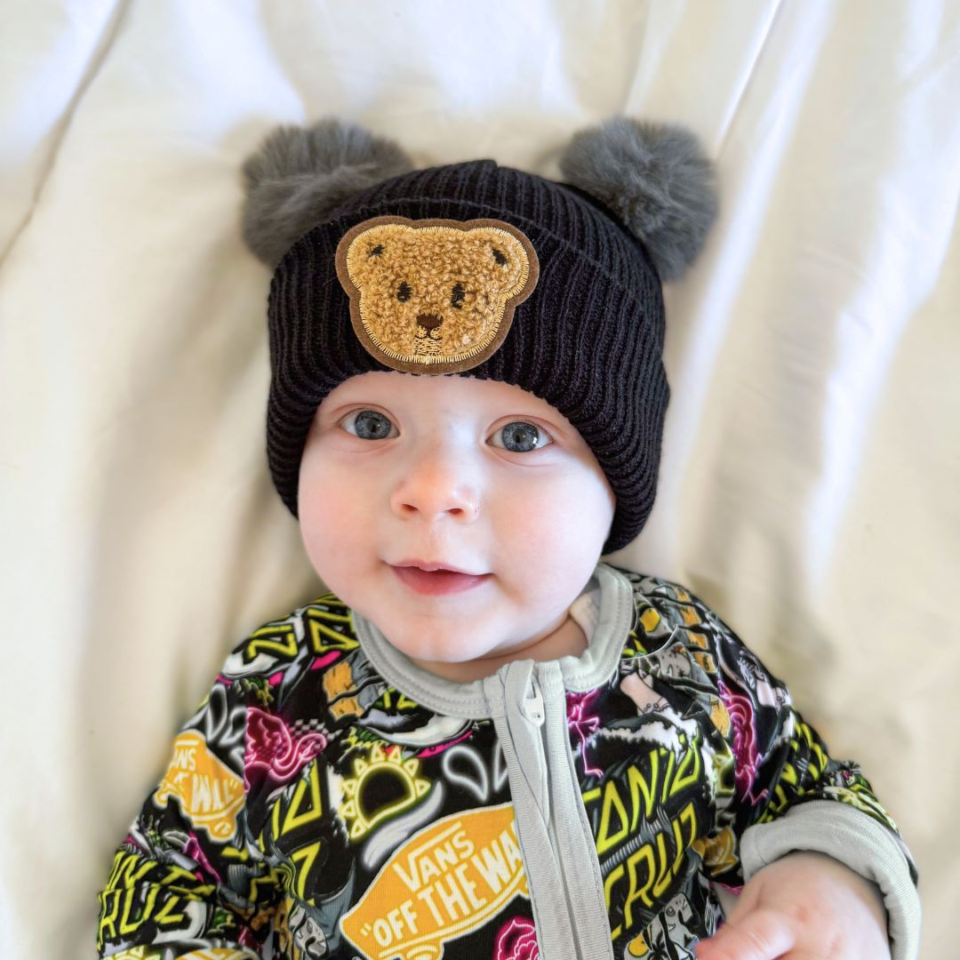 Cute smiling baby boy wearing Teddy Pom Pom Baby Beanie in black