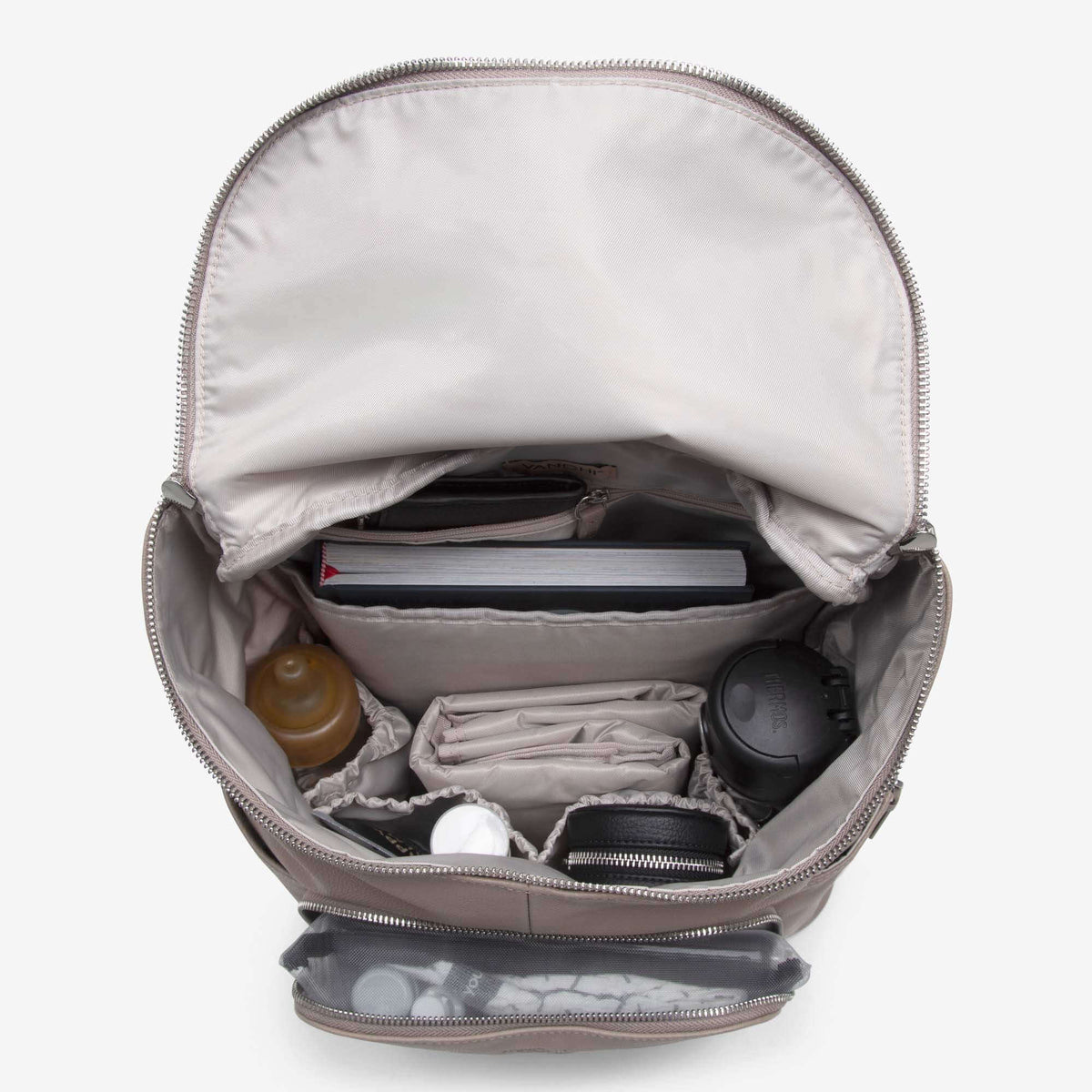 Inside the Frankie leather nappy backpack, packed with laptop, bottles and baby essentials