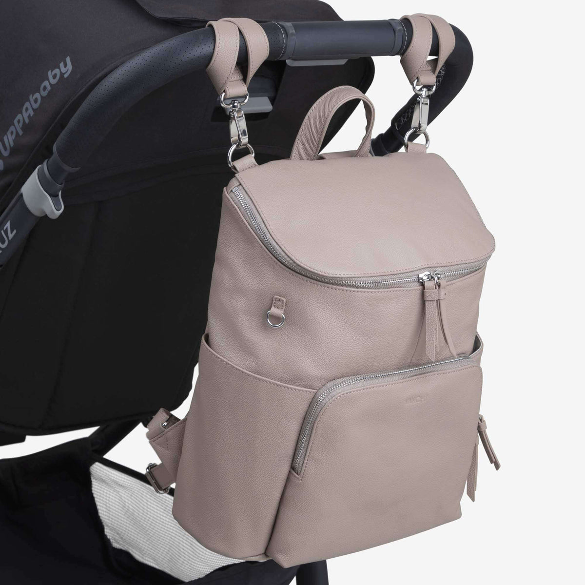 Frankie leather nappy backpack hanging from pram clips (sold separately) – close-up