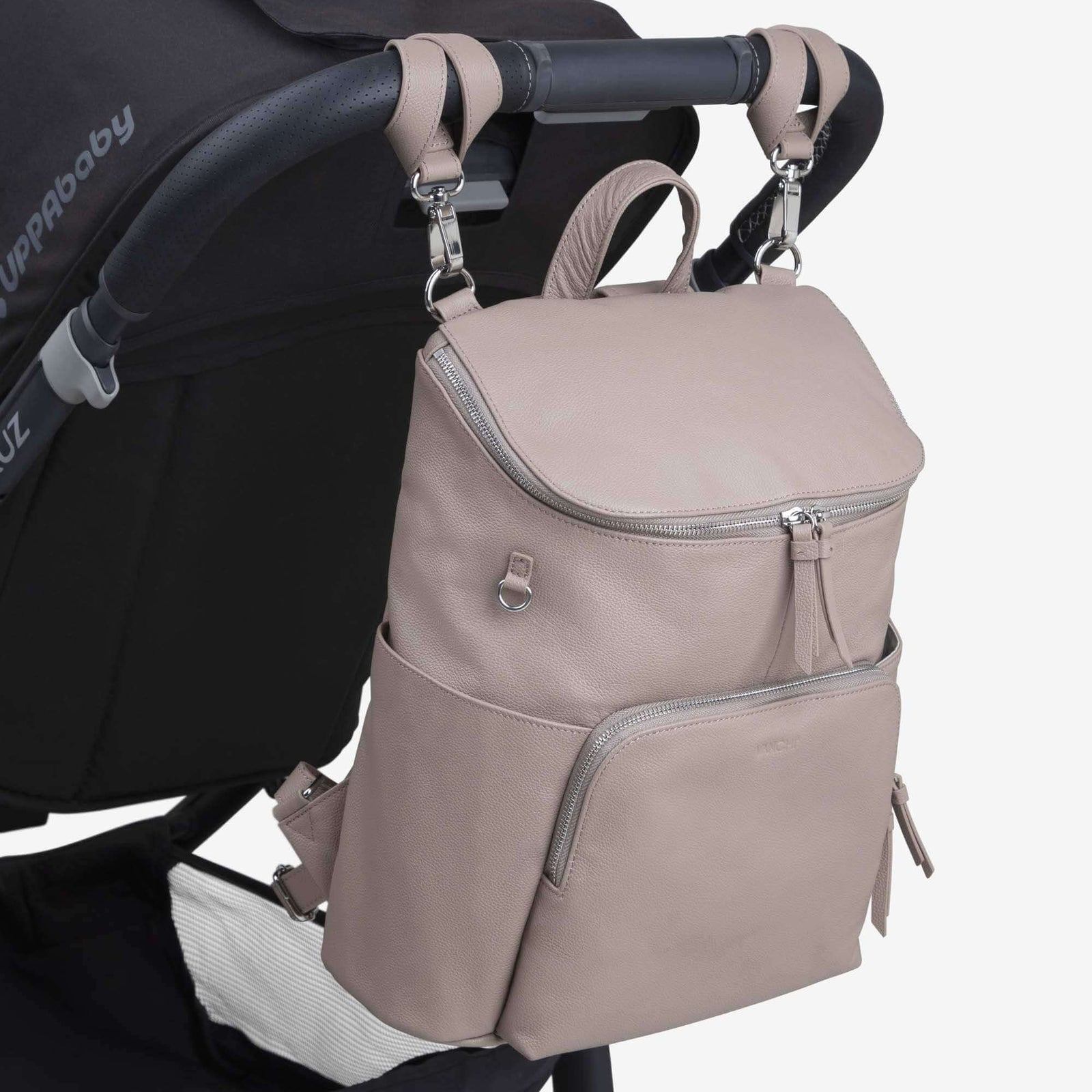 Frankie leather nappy backpack hanging from pram clips (sold separately) – close-up