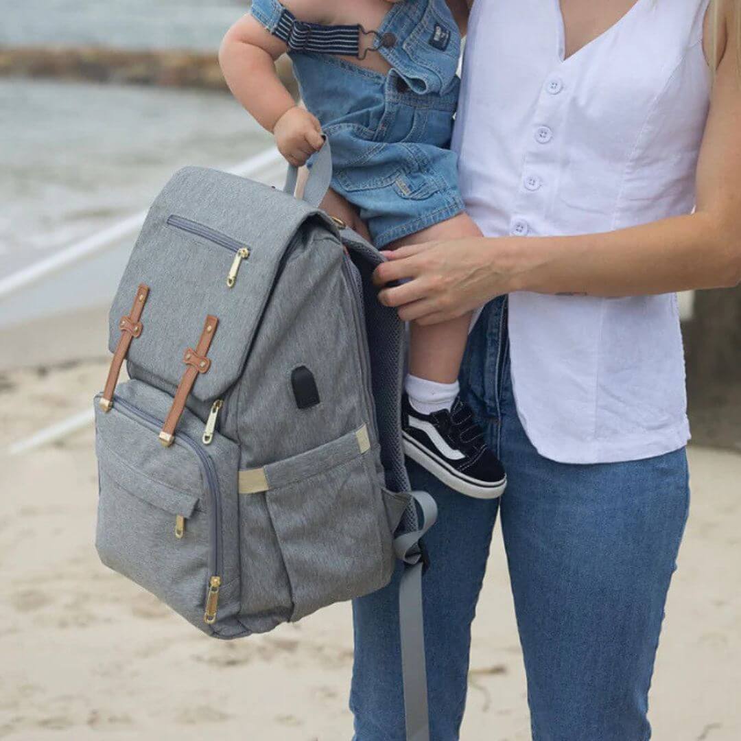 Mum holding grey Nappy Backpack, stylish and lightweight