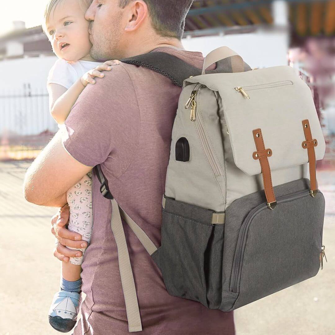Dad wearing the Vienna Nappy Backpack in white and grey (also comes in pink and grey, black, and other stylish colours)