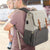 Dad wearing the Vienna Nappy Backpack in white and grey (also comes in pink and grey, black, and other stylish colours)