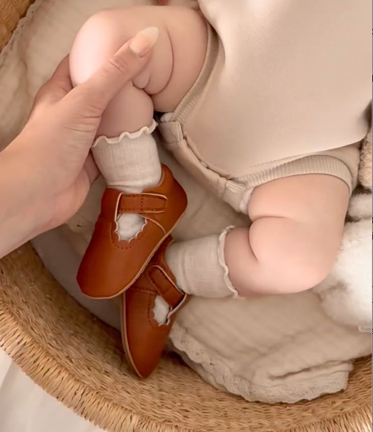Baby wearing vintage T-Bar Baby Shoes in tan vegan leather from Lulu Babe