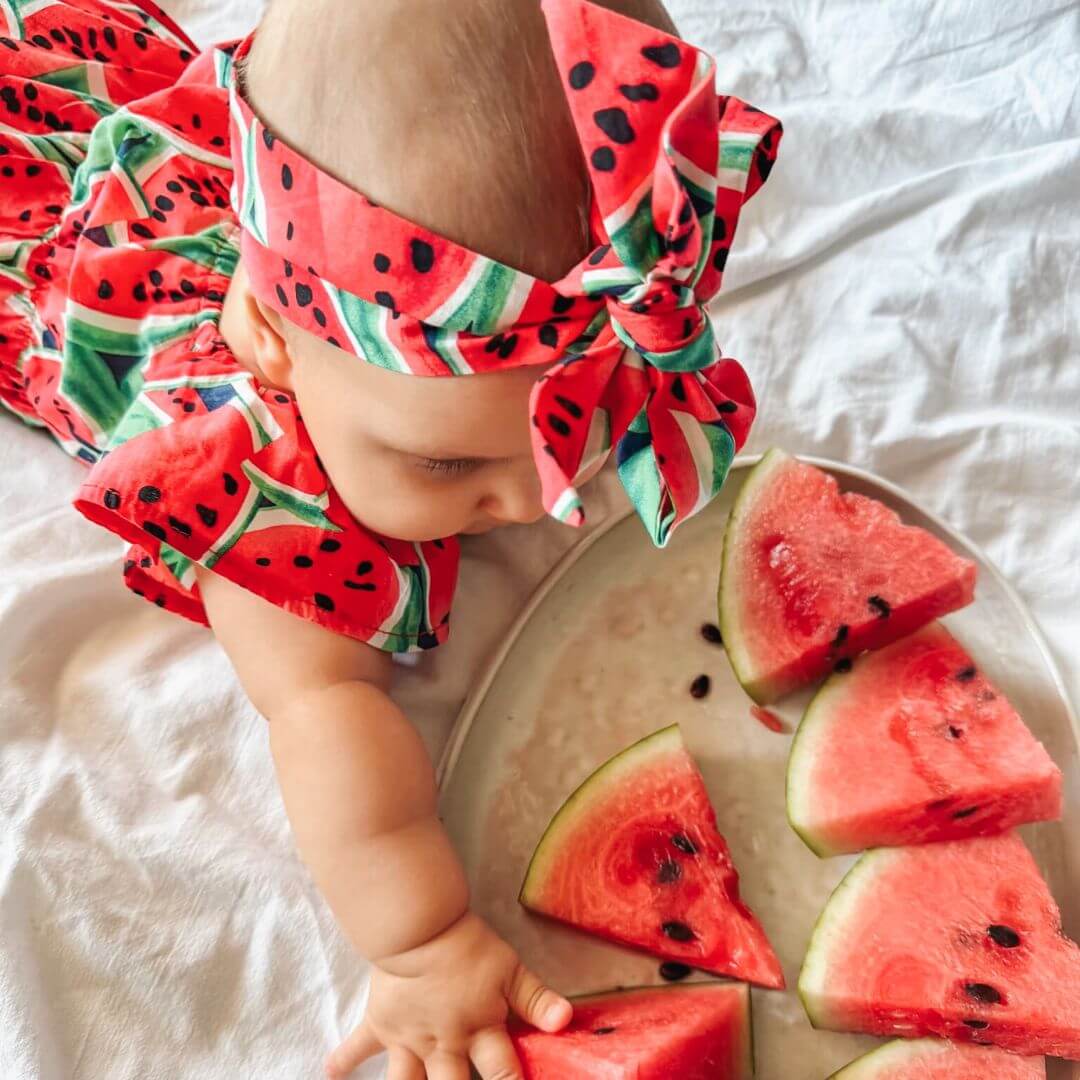 Baby girl wearing Watermelon Romper from Lulu Babe (in 3-6 months, 6-12 month &  12-18 months, 18-24 months & 2-3 years)