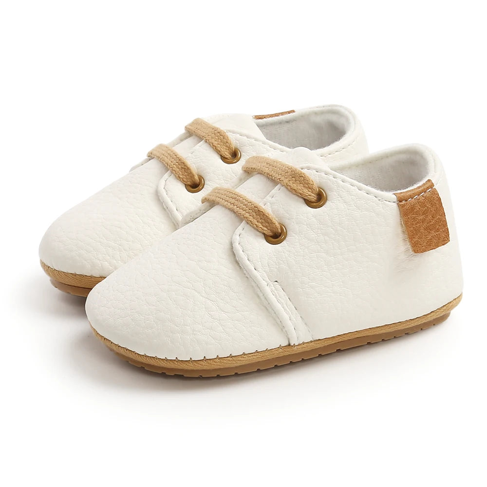 White lace-up oxford style baby shoes