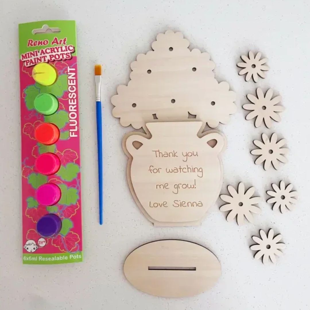 Personalised wooden flower paint kit showing engraved vase, six wooden flower blanks, fluorescent acrylic paints and paintbrush