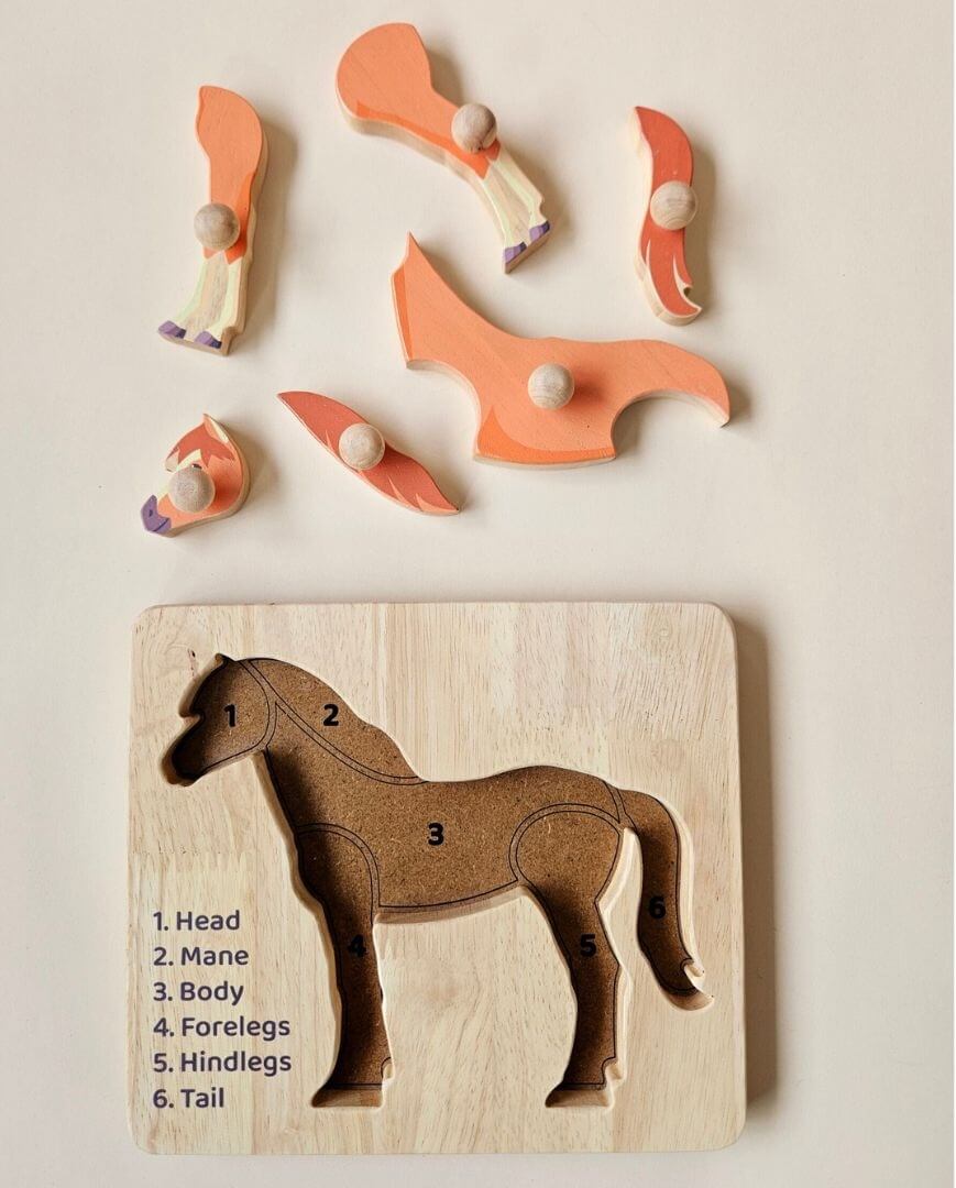 Horse knob puzzle pieces lifted out, showing the numbered cut-outs for head, mane, body, forelegs, hindlegs and tail