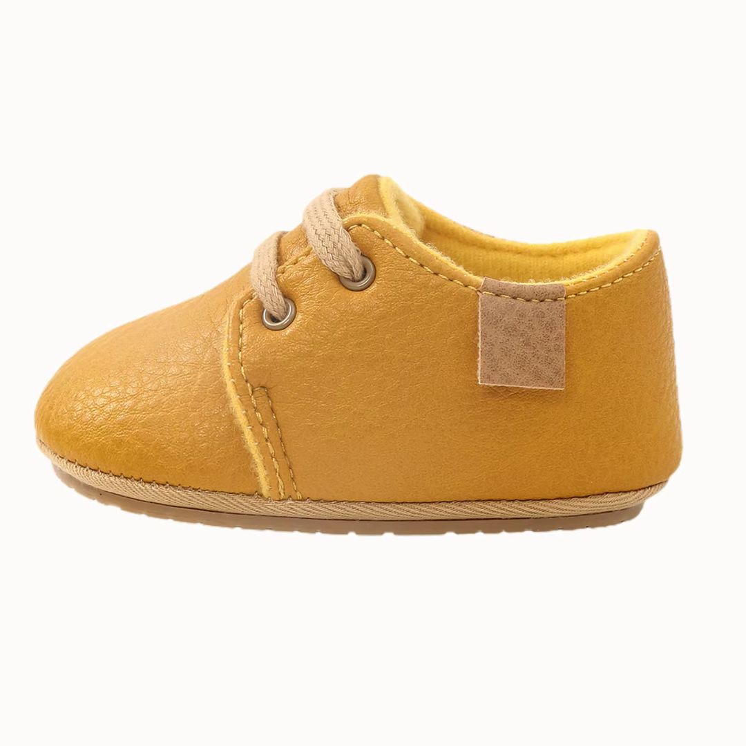 Yellow lace-up oxford style baby shoes - side view