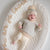 "You are so loved" Wooden Script styled next to baby in bassinet