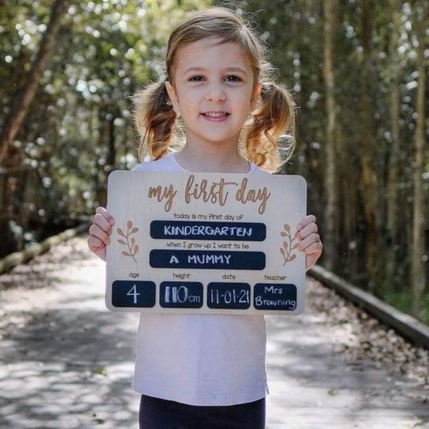 Girl holding First Day of School Wooden Board