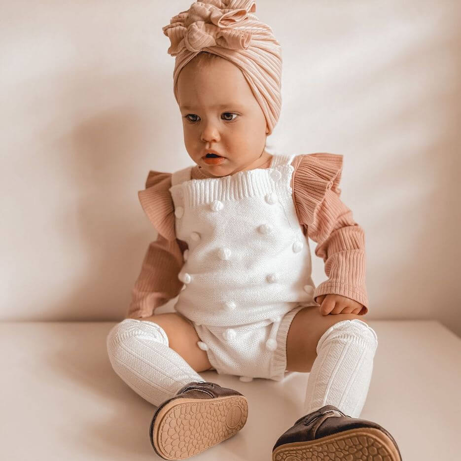 Adorable baby girl outfit - wearing our ribbed long sleeve flutter romper in pink, layered under another romper