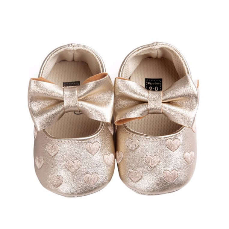 Gold baby moccasins with embossed hearts and bow detail - soft sole 0-18 months