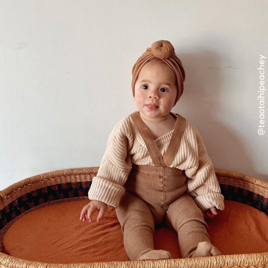 Adorable baby girl wearing ribbed suspender tights in latte - from Lulu Babe