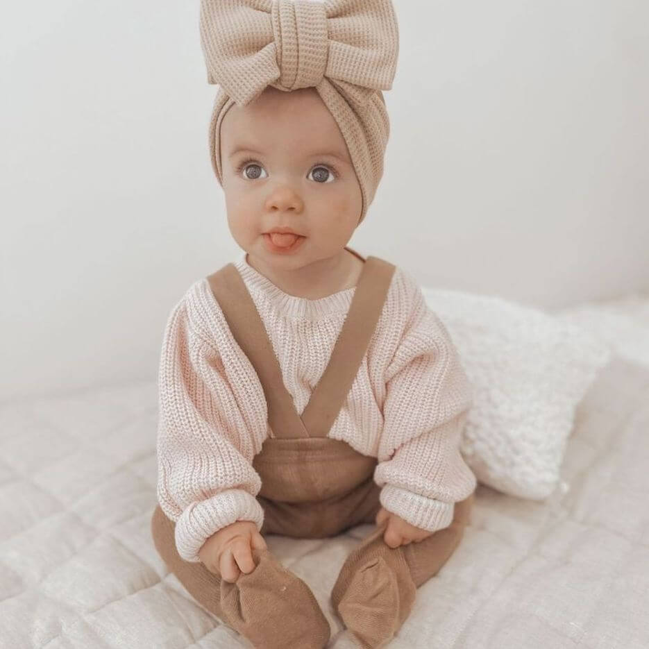 Cute baby girl wearing ribbed suspender tights in latte - from Lulu Babe