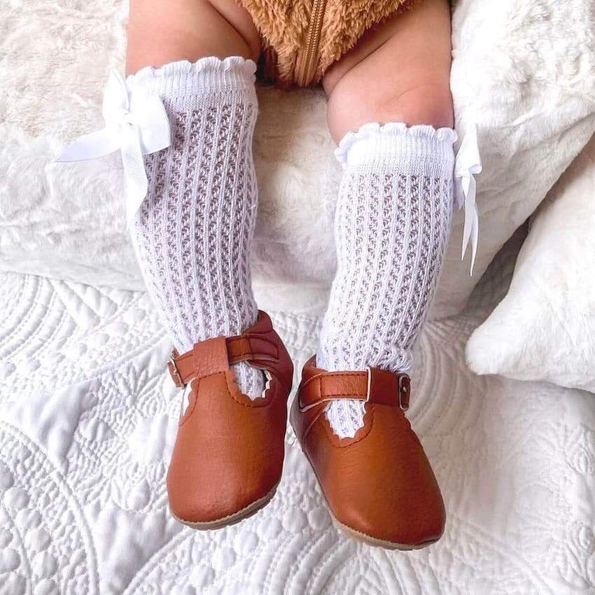 Baby wearing vintage T-Bar Baby Shoes in tan vegan leather from Lulu Babe